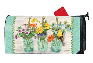 MailWrap with 3 mason jars full of wildflowers and a goldfinch perched on one of the vases