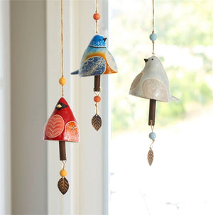 Sample image of three different designs of Bird Song Bells hanging together in the window