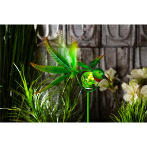 36"H Solar Hummingbird Staked Wind Spinner lit up at night